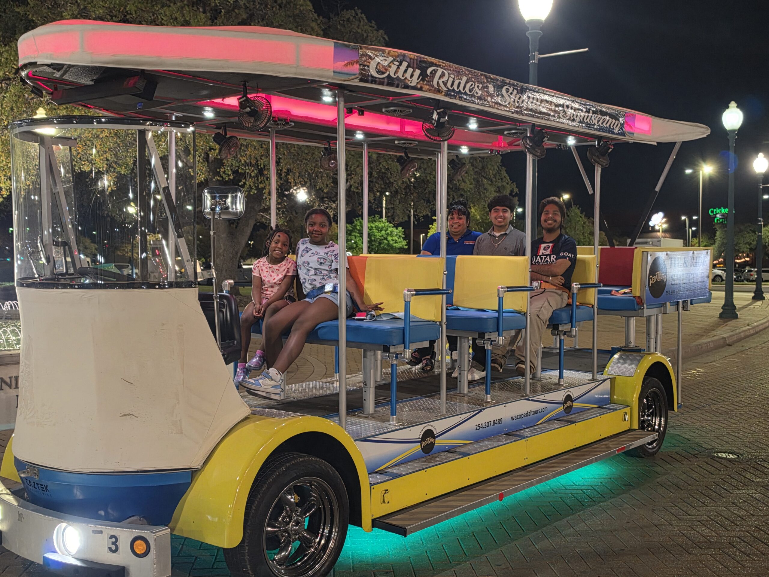 Tip and Ride Shuttle at night near Dr Pepper sign