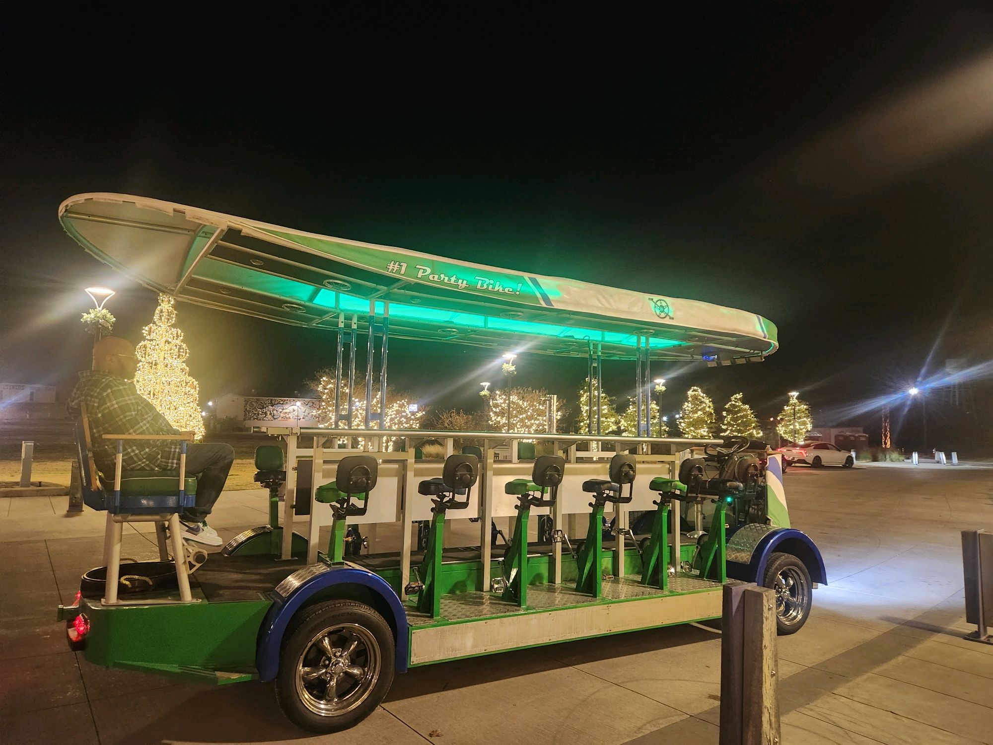 Waco Pedal Tours party bike glowing with green LED lights at night