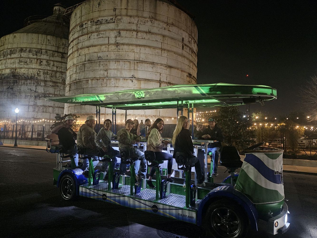 Group of riders pedaling the Waco Pedal Tours party bike during the day